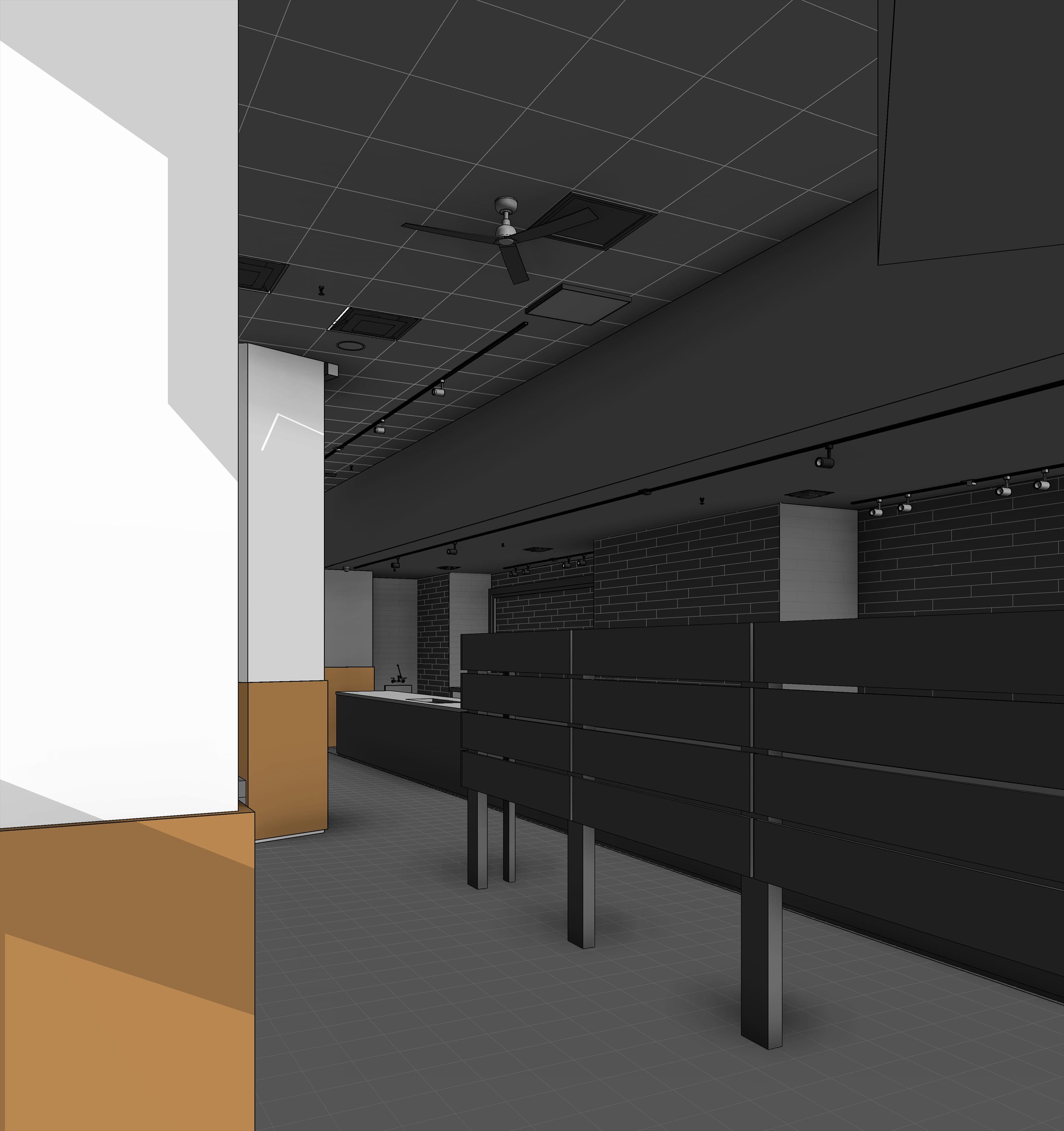 An interior view toward the back of the floor, with a dark brick wall, track lighting and the counter running away from the camera.