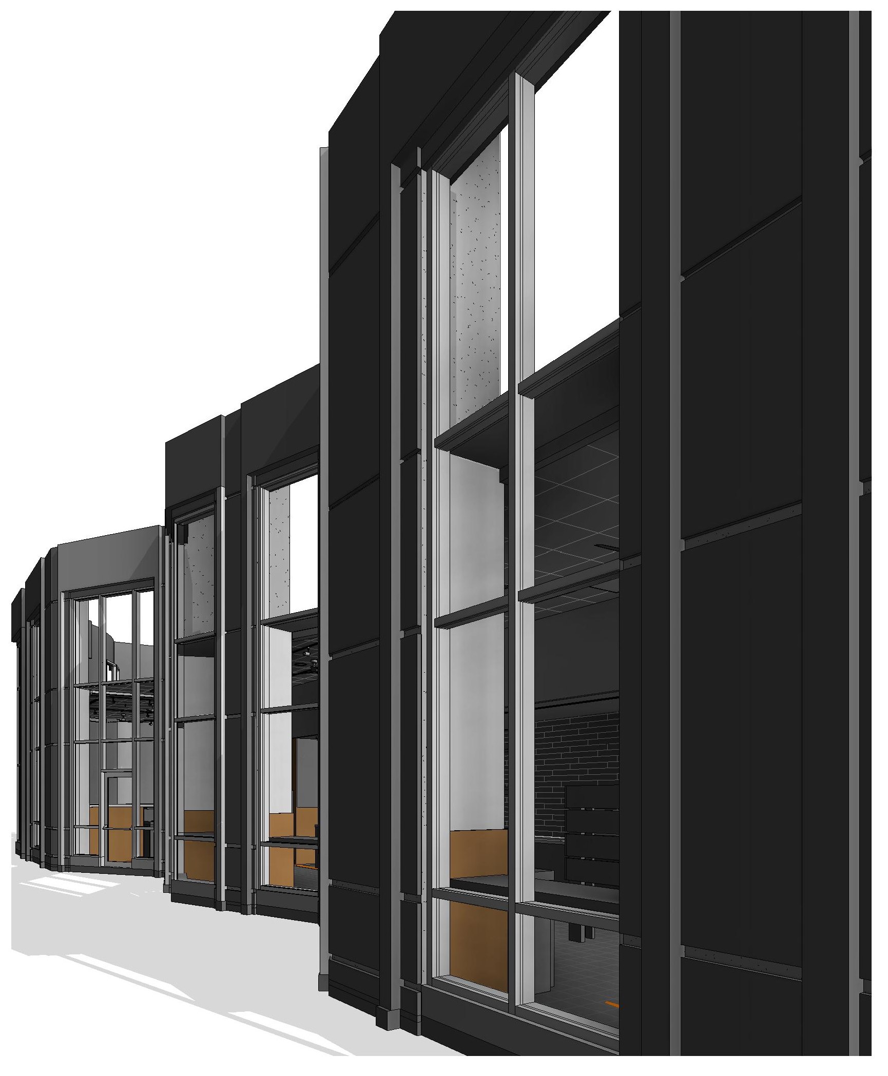 An exterior view along the storefront, showing the full-height glazing bays and mullion grid with the interior visible behind.